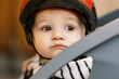 © Serena Burroughs/Stocksy - adorable portrait of baby in bicycle seat with helmet