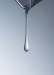 © Tatyana Lavrova/Stocksy - Close-up of face serum droplet against gradient blue background.