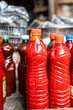 © Alvaro Lavin/Stocksy - Bottles of red palm oil at market stall
