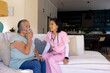 © Wavebreak Media - Asian senior woman with oxygen mask, assisted by nurse healthcare worker in scrubs, at home