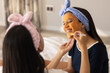 © Wavebreak Media - Two biracial young sisters enjoying face mask treatment together in a cozy bedroom, at home