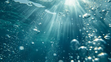 Wall Mural - Underwater view with sunlight streaming through water and air bubbles.