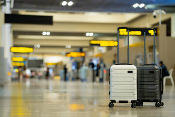 Wall Mural - Travel, Two suitcases in an empty airport hall, traveler cases in the departure airport terminal waiting for the area, vacation concept, blank space for text message or design