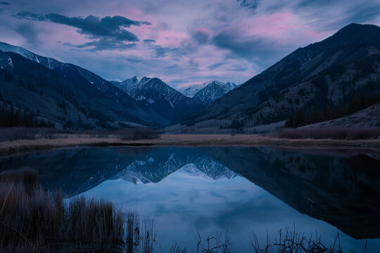 A tranquil mountain lake at dusk, capturing a reflective and calm state of mind.