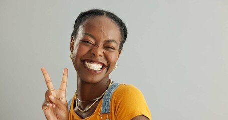 Wall Mural - Portrait, peace sign and black woman with smile, support and motivation on grey studio background. African person, face and model with hand gesture, v symbol and excited with icon, feedback or review