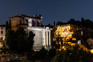 Rome, Italy - April 09, 2024: Night view of the ruins of the Roman Forum in Rome with tourists crowding its surroundings in Rome, Italy