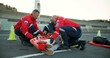 © CineLens/peopleimages.com - People, paramedic and help patient in road on scene for emergency, rescue and support. Emt team, healthcare and stretcher for injured person on accident for medical service, care and first aid