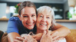 © AchillesReel/peopleimages.com - Happy woman, portrait and hug with senior patient in elderly care, love or nursing at retirement home. Female person, nurse or caregiver with smile for embrace, healthcare or bonding at old age house