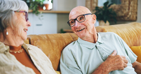 Canvas Print - Senior couple, talking and happy on sofa with memory, care and bonding with love in home living room. Elderly woman, old man and smile for conversation, connection and retirement on couch in house