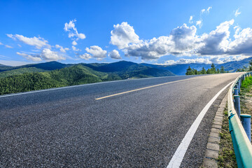 Wall Mural - Asphalt highway road and green mountain nature landscape under blue sky