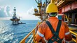 © WITTAYA  ANGMUJCHA - oil worker wearing a new safety helmet standing on offshore platform
