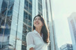 © song - Smiling Asian Office Lady in Office Building Background