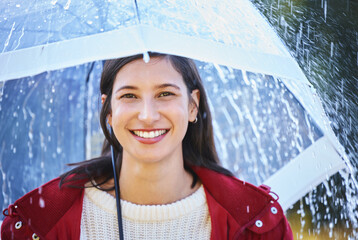 Wall Mural - Rain, portrait and woman with umbrella for winter climate and weekend walk for relax outdoor. Happy female person, insurance or safety shield from storm weather with water drops in nature park