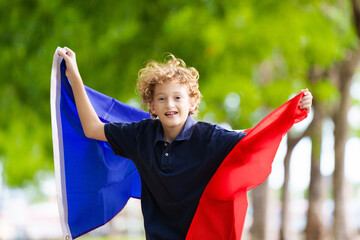 Wall Mural - Child with French flag. Kid cheering for France.