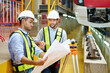 © offsuperphoto - Workers or engineers talking about work and checking blueprint paper at construction train station