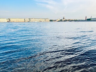 city river view, river in the city center, blue sky, white clouds, summer