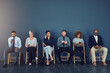 © peopleimages.com - Business people, recruitment and waiting in row with technology for hiring process and employment opportunity. Diverse group, job seeker and phone in line for HR meeting with mockup space and banner