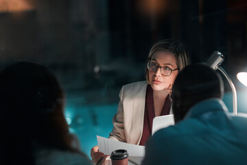 Poster - Meeting, night and woman with document in office, listening and deadline for project and planning. Collaboration, paperwork and business people, proposal and teamwork for financial records in dark