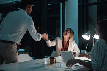 Fototapete - Handshake, night and woman with smile in office, happy and deadline for project and planning in dark. Collaboration, online and business people, proposal and boardroom for financial records in chart