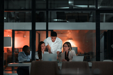 Fototapete - Collaboration, laptop and business people in office at night with stock market charts for corporate investment. Discussion, computer and financial advisors work on company profit report with deadline