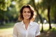 © CogniLens - Portrait of a satisfied woman in her 20s wearing a classic white shirt isolated in bright and cheerful park background