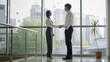 © Yuliia - Two business partners colleagues people shaking hands in office Caucasian woman and man handshaking greeting talking in lobby corridor cooperation welcome businesswoman handshake with businessman