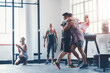 © peopleimages.com - Celebration, gym and team with hug, fitness and clapping for success, athlete and club for sports. Congratulations, happy and applause for exercise, practice and people together for workout in class