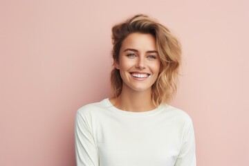 Wall Mural - Portrait of a grinning woman in her 30s sporting a long-sleeved thermal undershirt isolated in pastel or soft colors background