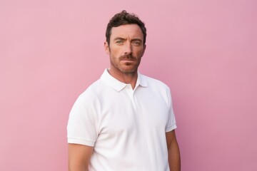 Wall Mural - Portrait of a glad man in his 30s wearing a breathable golf polo while standing against pastel or soft colors background