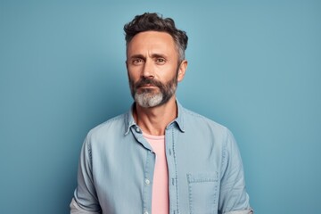 Poster - Portrait of a content man in his 40s sporting a versatile denim shirt in pastel or soft colors background