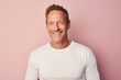 © CogniLens - Portrait of a grinning man in his 40s sporting a long-sleeved thermal undershirt isolated on pastel or soft colors background