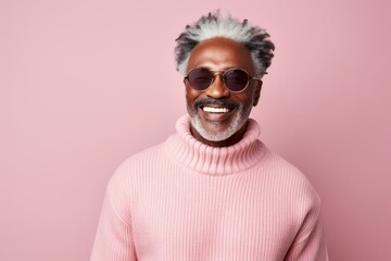 Wall Mural - Portrait of a tender afro-american man in his 50s wearing a thermal fleece pullover on pastel or soft colors background