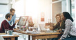 © peopleimages.com - Discussion, computer and business people at desk in coworking space for collaboration, planning project or feedback. Lens flare, diversity and staff at design agency for teamwork, review or report