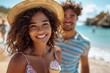 © Pinklife - Attractive young woman with a beach backdrop smiles holding ice cream with a man partially visible
