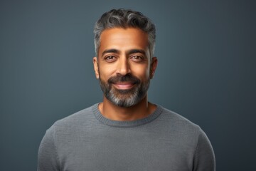 Poster - Portrait of a blissful indian man in his 40s wearing a classic turtleneck sweater isolated on minimalist or empty room background