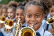 © denklim - Young Girl Playing Saxophone in School Band Performance