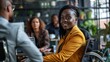 © Denisa - A woman smiles while sitting in a wheelchair during a meeting
