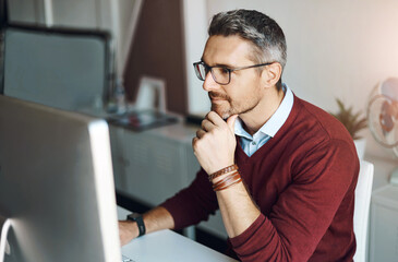 Remote work, man and computer with glasses for thinking, response and research in home office. Male freelancer, technology and idea at desk for communication, review and planning on internet