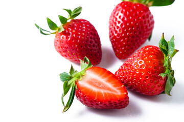 Wall Mural - Strawberries isolated. Ripe sweet strawberries and half a berry on a white background. 2