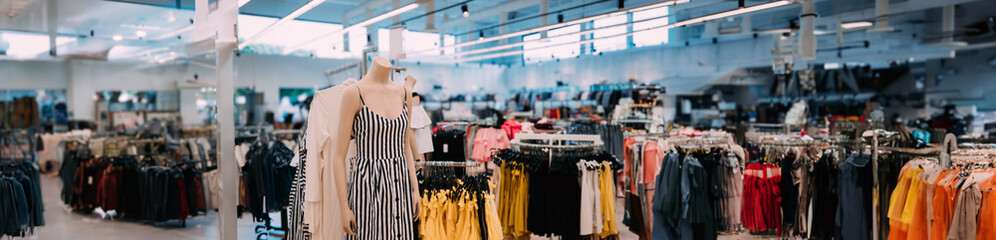 Poster - Mannequin Dressed In Female Casual Dress And Clothes On Shelves And Hanger In Store Of Shopping Center