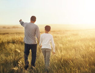 Wall Mural - Back, field and father with son, walking and adventure with sunshine, getaway trip and bonding together. Family, single parent and dad with kid, boy and childhood with weekend break, nature or travel