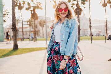 Wall Mural - pretty smiling woman walking in city street