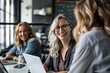© ORG - Businesswoman, laptop and happy team in the office working together and training, planning, digital marketing, and coaching.