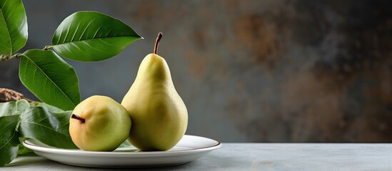 Leinwandbilder - Fresh bio pear with leaves on the plate Gray stone table. Creative banner. Copyspace image
