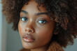 © Natalia - Simple photo of a woman with soft curls, set against a clean, neutral background,