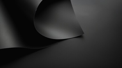 Matte black paper with a subtle texture, ideal for a sophisticated background.