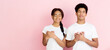 © Prostock-studio - Kind-hearted teens holding their hands togehter on chest being thankful, pink background