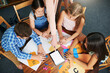 © Arnell K/peopleimages.com - Children, teacher and tablet for education with help, mockup space and blank screen in classroom. People, above and group learning with books, math and point at touchscreen for development at school