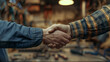 © Mutshino_Artwork - Handshake Between Workers in Industrial Workshop Setting