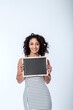 © Mark Skeet - Beautiful young woman holding a chalkboard sign with space for ad copy or messaging. Copy Space